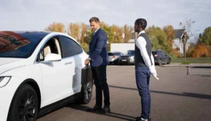 NYC Airport Transfers with ZechionRide – Reliable, Premium & Stress-Free Travel (2025 Guide) 9 Chauffeur waiting for an executive beside a luxury vehicle, highlighting ZechionRide’s professional corporate transportation services in NYC.
