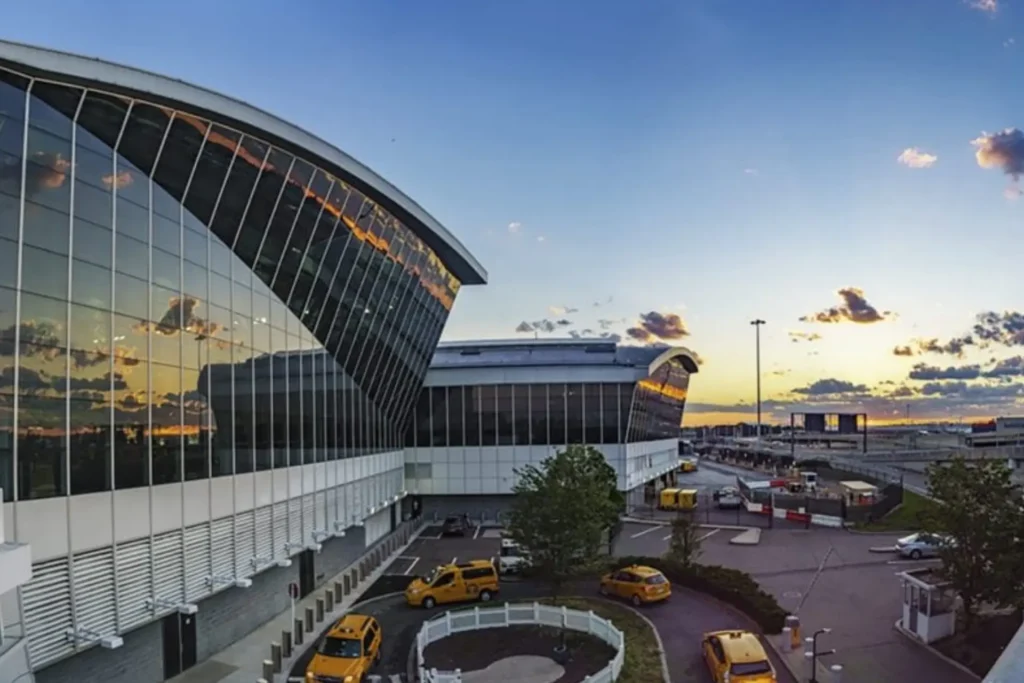 Scenic sunset from NYC airport terminal with skyline glowing in golden hues