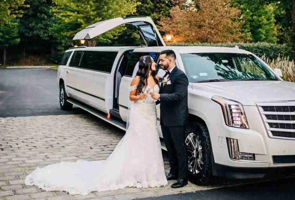 Wedding Transportation 5 A couple at their wedding, with a stylish limo in the background