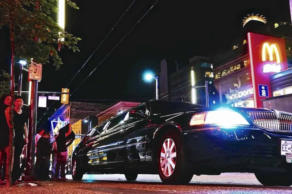 Limousine Packages 9 Limousine parked on the roadside at night, highlighting its role in nightlife transportation