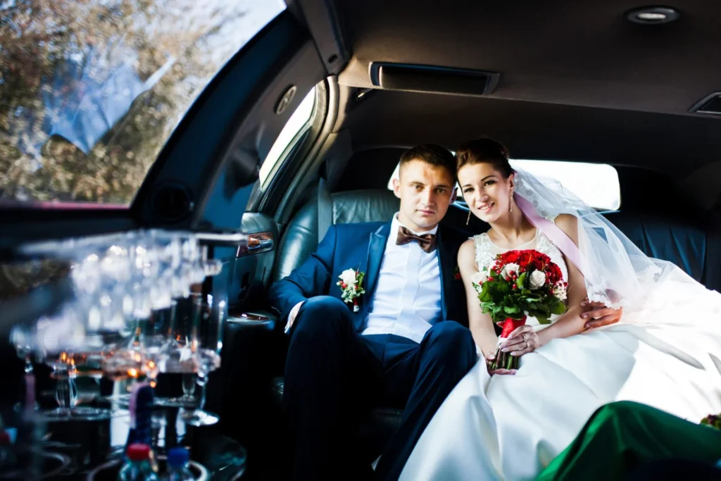 Limousine Packages 5 Newlyweds relax in the back of a limo, enjoying their wedding day ride together