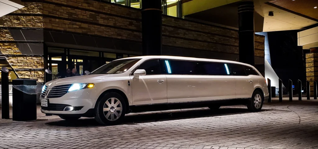 Hotel Transportation 6 White limousine parked in front of a hotel
