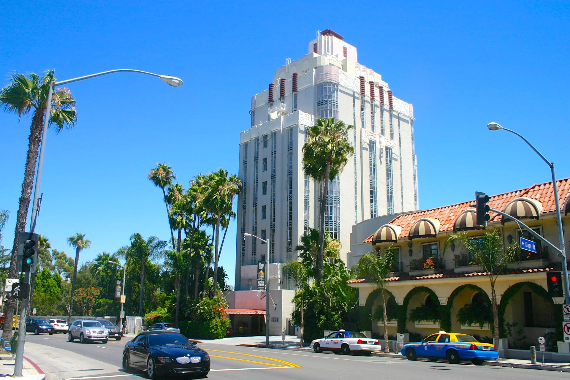 Los Angeles 26 A tall building in West Hollywood, Los Angeles, with palm trees in front, showcasing a sunny urban landscape