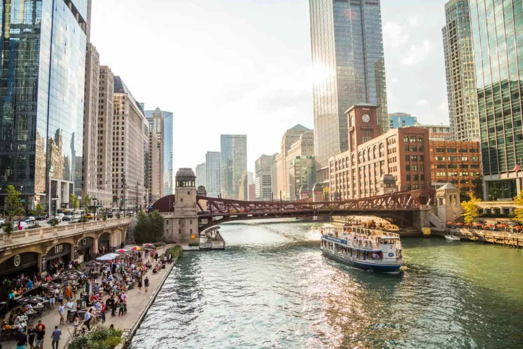 Downtown Chicago's Riverwalk alongside the Chicago River, featuring vibrant city life and picturesque waterfront views
