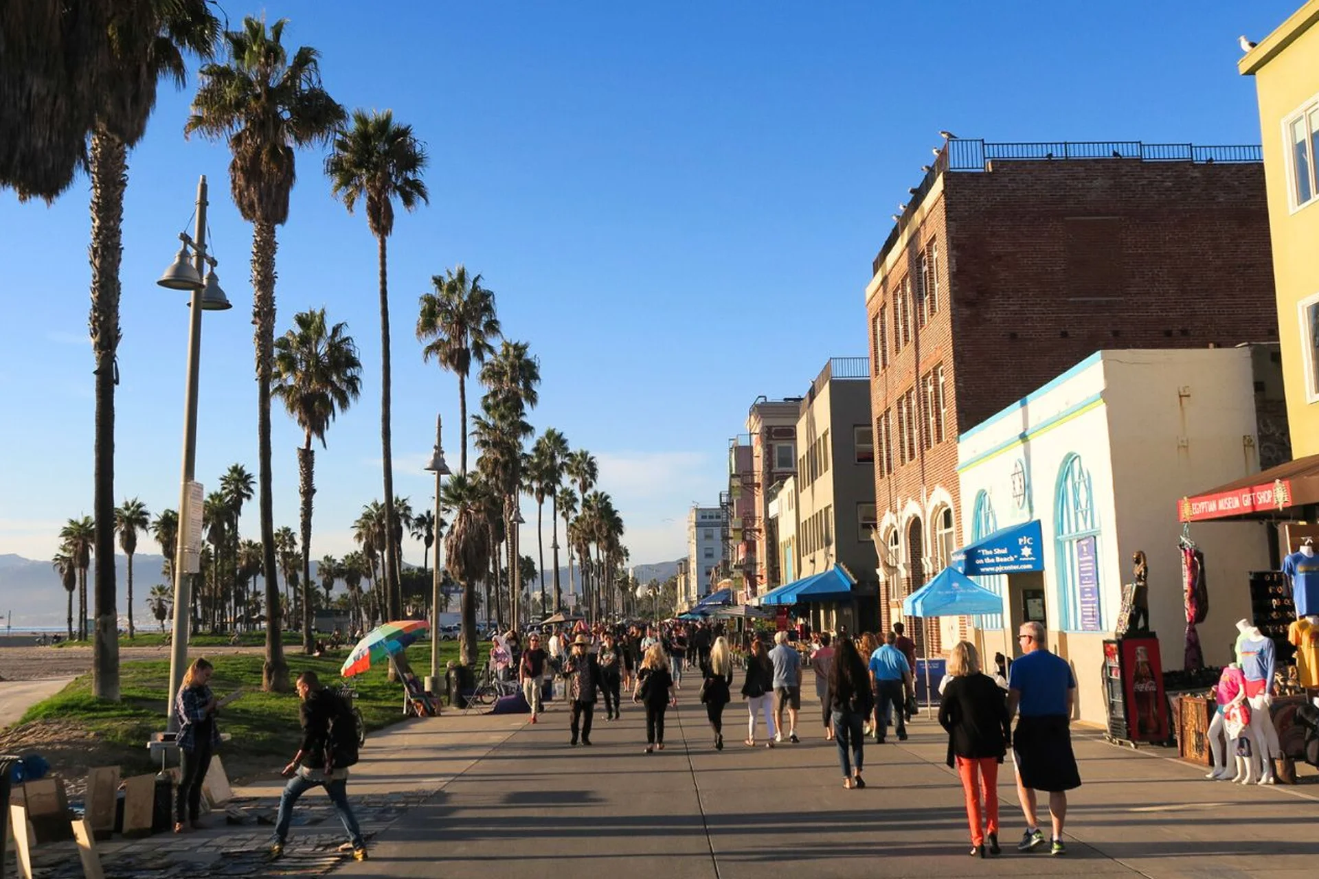 Los Angeles 20 People stroll along the bustling Venice Beach boardwalk in Los Angeles, enjoying the vibrant atmosphere and ocean views