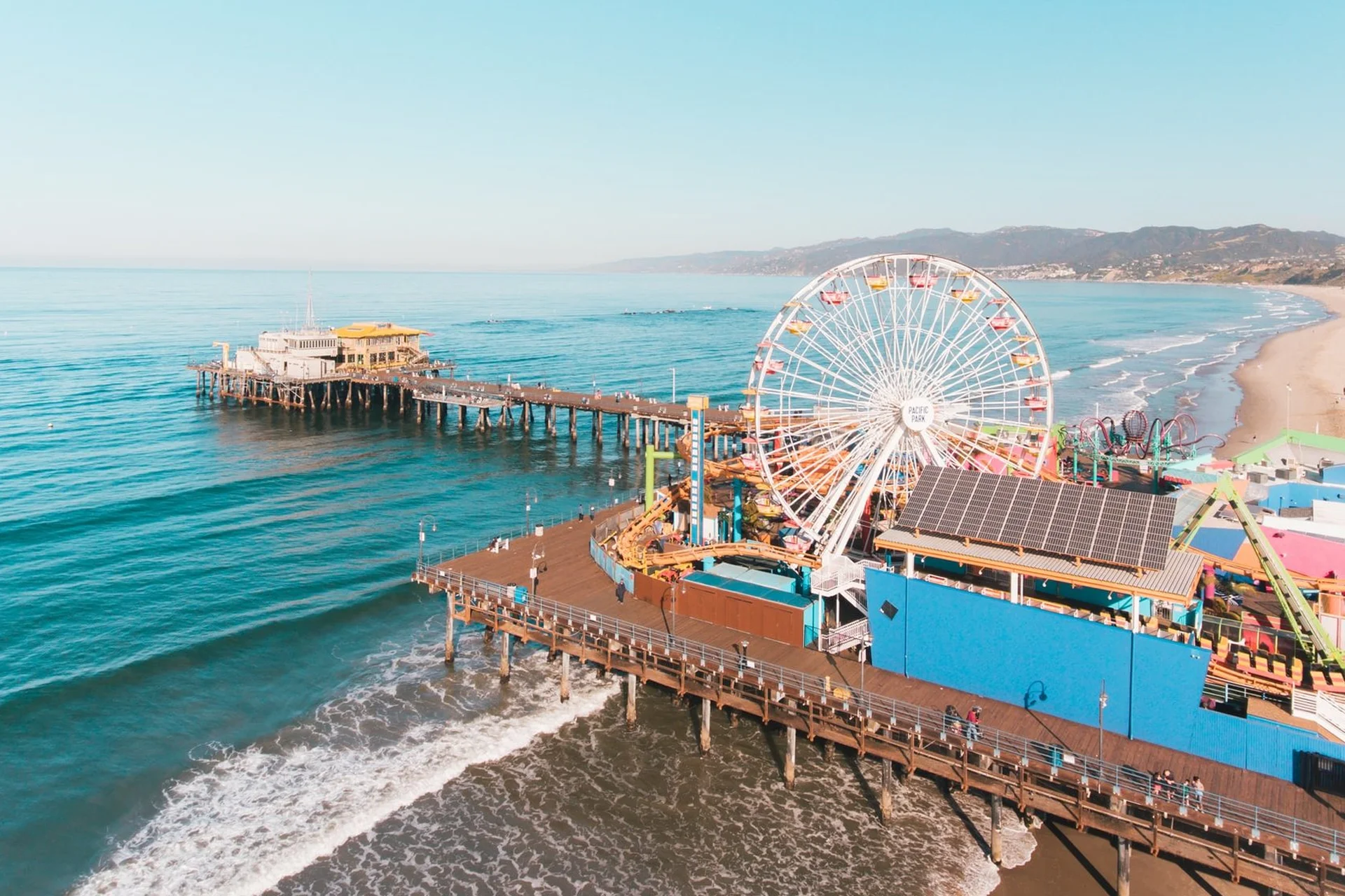 Los Angeles 13 View of Santa Monica Pier featuring a colorful ferris wheel and the coastline of Los Angeles