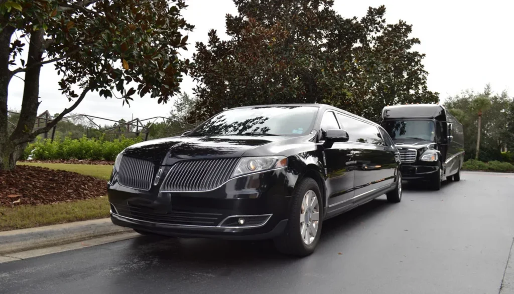 Florida Luxury Limousines vs. Traditional Transportation 2 Black limousine next to a bus, highlighting the diverse transportation choices in Florida