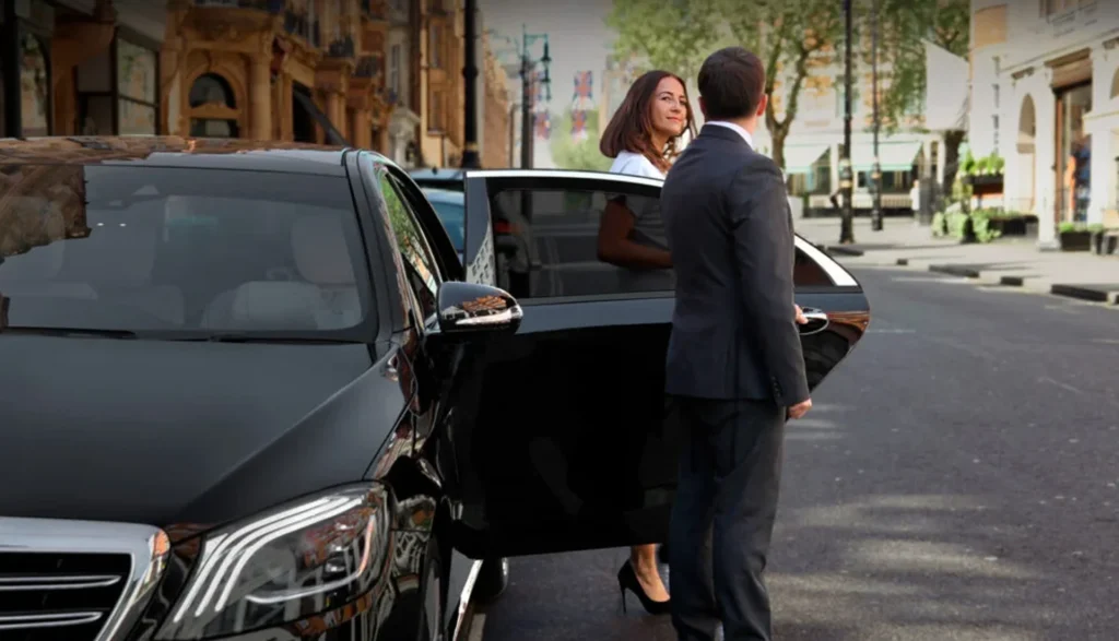 Florida Luxury Limousines vs. Traditional Transportation 3 Private chauffeur open door of black car & women getting out from