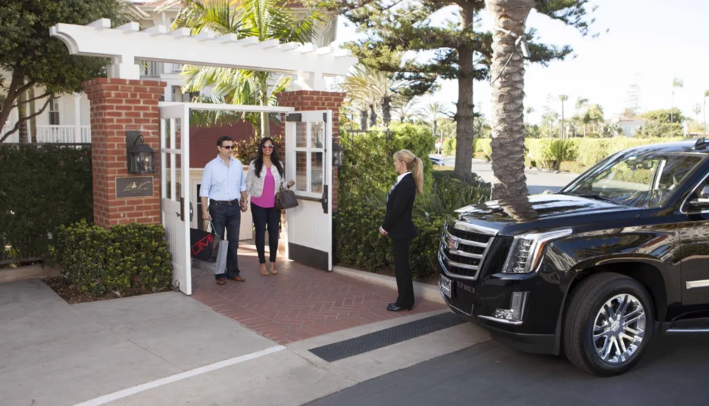 Black Cadillac SUV parked in front of a building promoting eco friendly and tech savvy limo service options